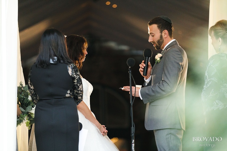 Groom Loren reading his vows