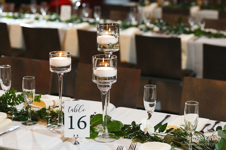candle votives and table number on reception table