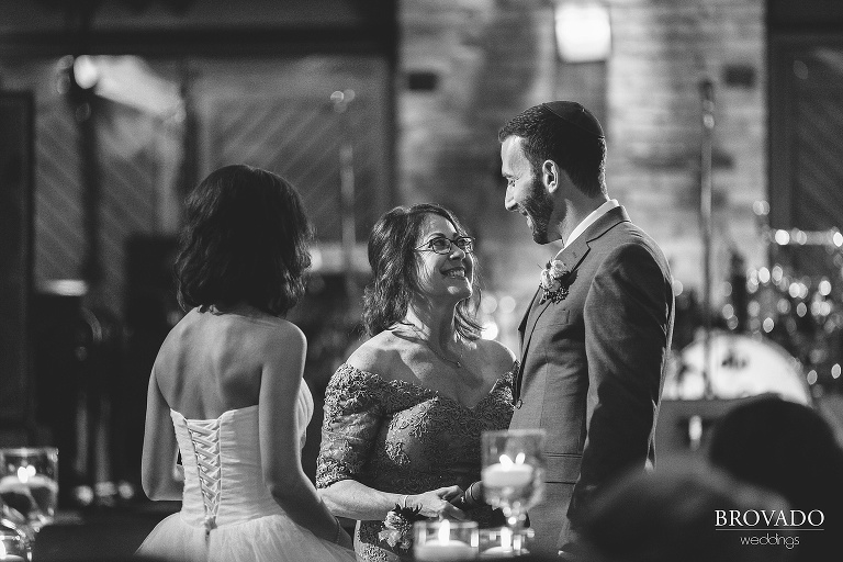 mother of the bride laughing with the bride and groom