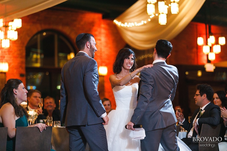 bride and groom talking to the best man