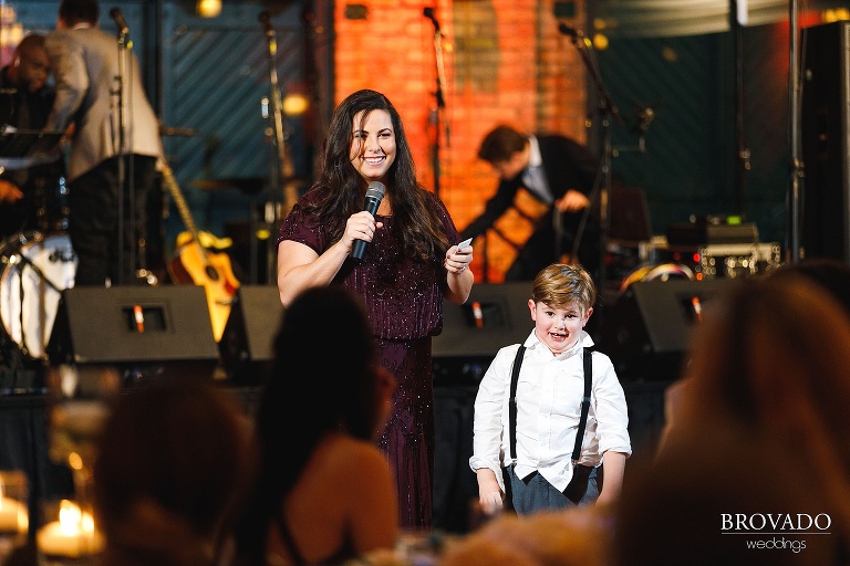 Sister of the bride and ringbearer giving speech at reception