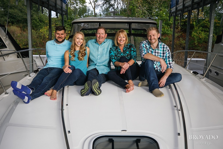 Family posing in blue outfits on their boat