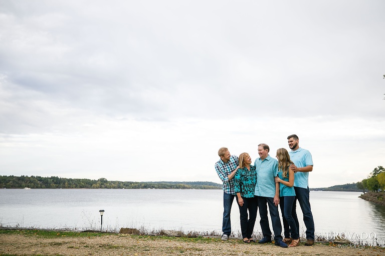 Anderson family standing in front of st croix river