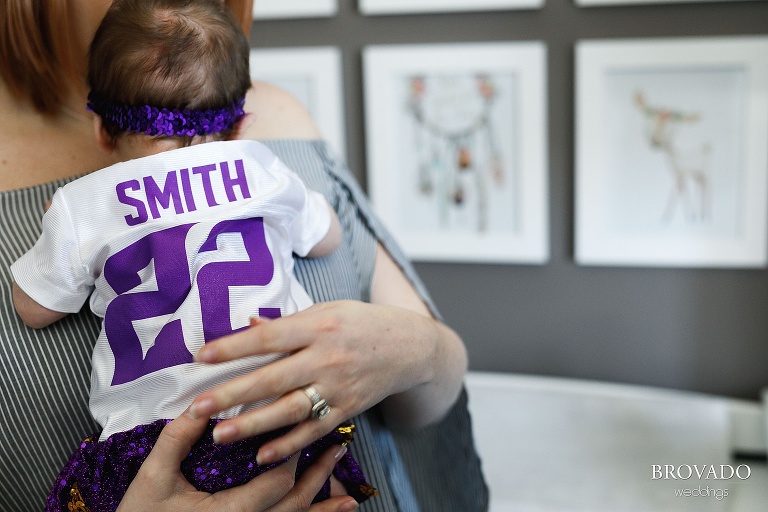 Newborn Nellie wearing baby vikings jersey