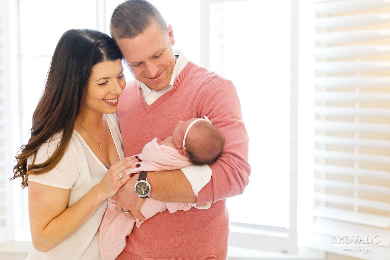 Jennae and Tyler holding their daughter in their living room