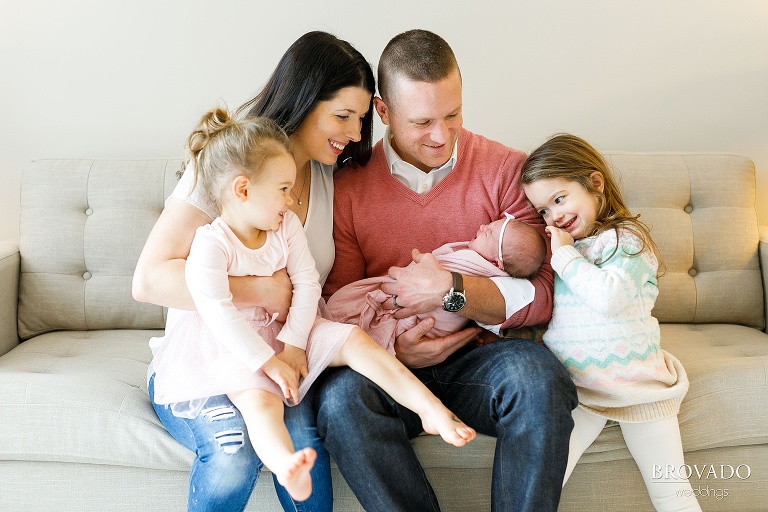 family photo with a newborn baby on the couch