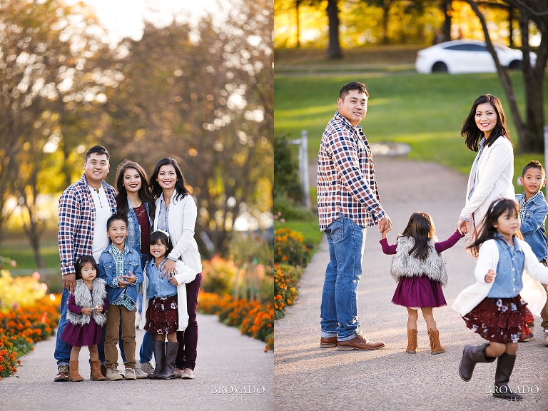 Coordinating family standing on flower lined pathway