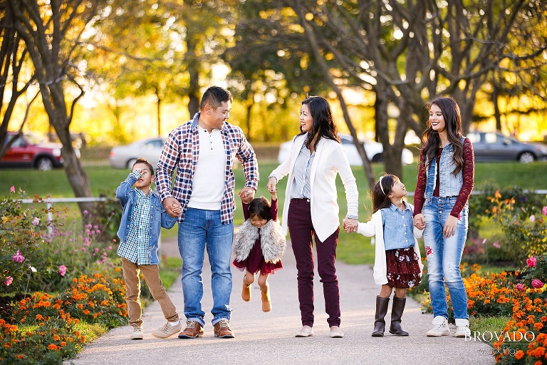 Family standing by orange flowers