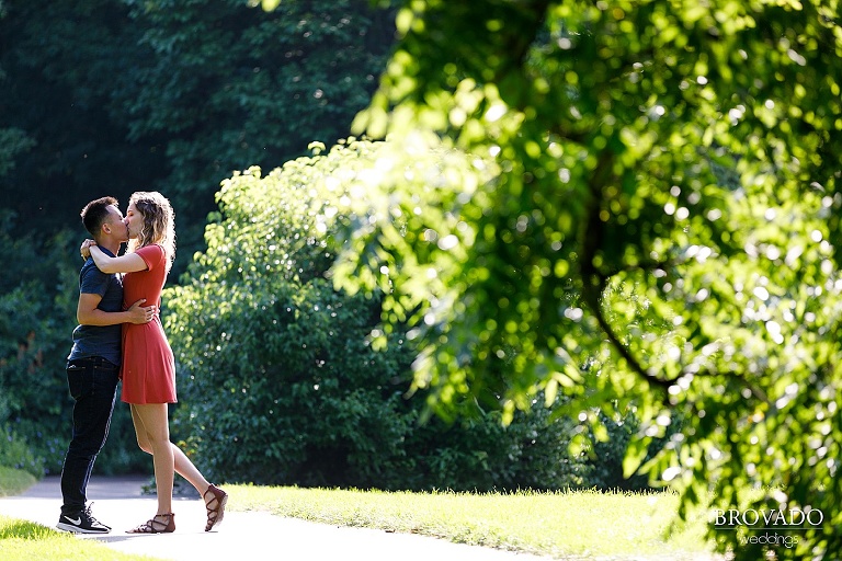 Engaged couple kissing at MN landscape arboretum