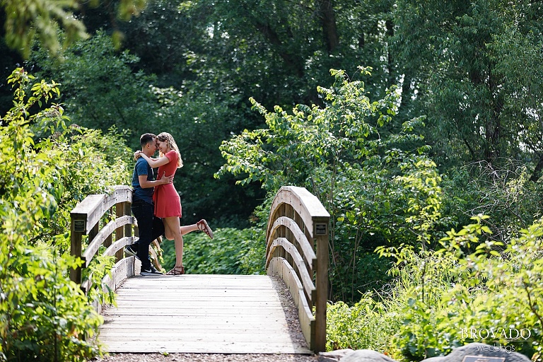 Sarah and Chris embracing on a bridge