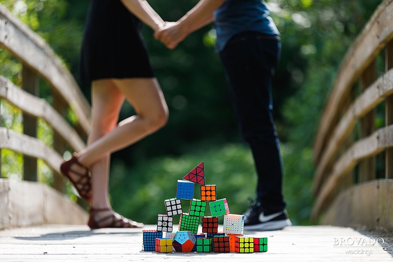 Chris and Sarah standing behind a pile of rubik's cubes