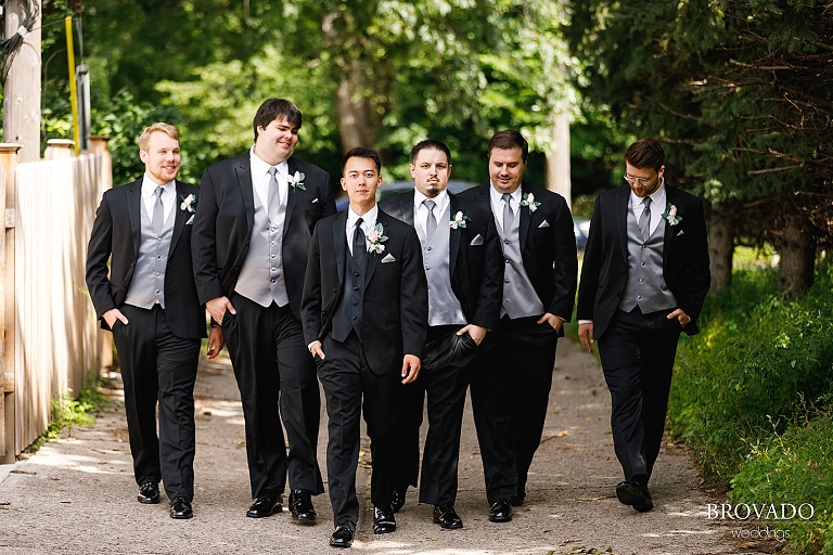 Chris and groomsmen walking down alley