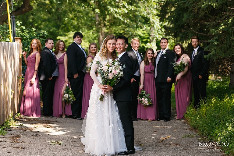 Bride and groom posing in front of wedding party