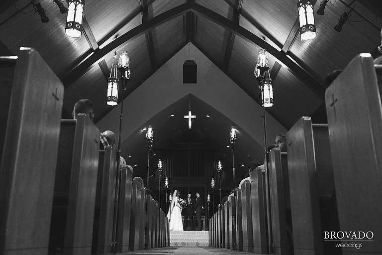 Wide angle of bride and groom at the altar
