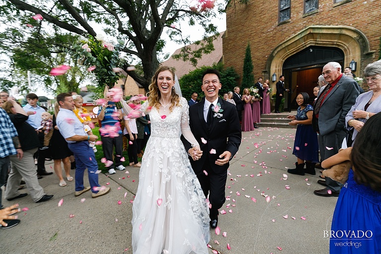 Blurry candid petal toss exit from church