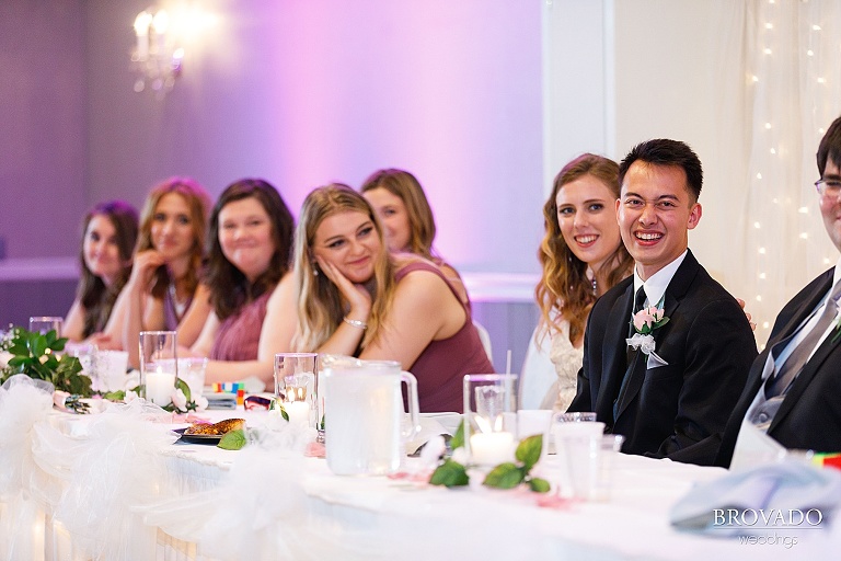 Groom laughing during speeches