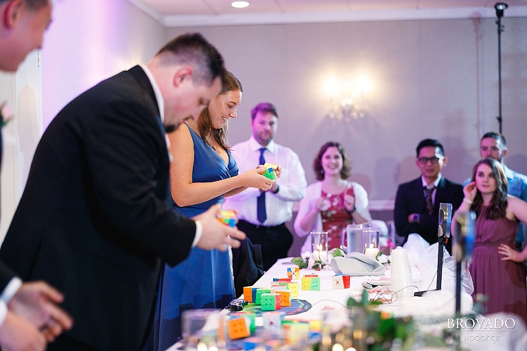 Wedding guests solving rubik's cubes at reception