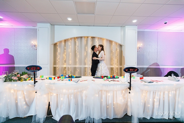 Bride and groom kissing at reception