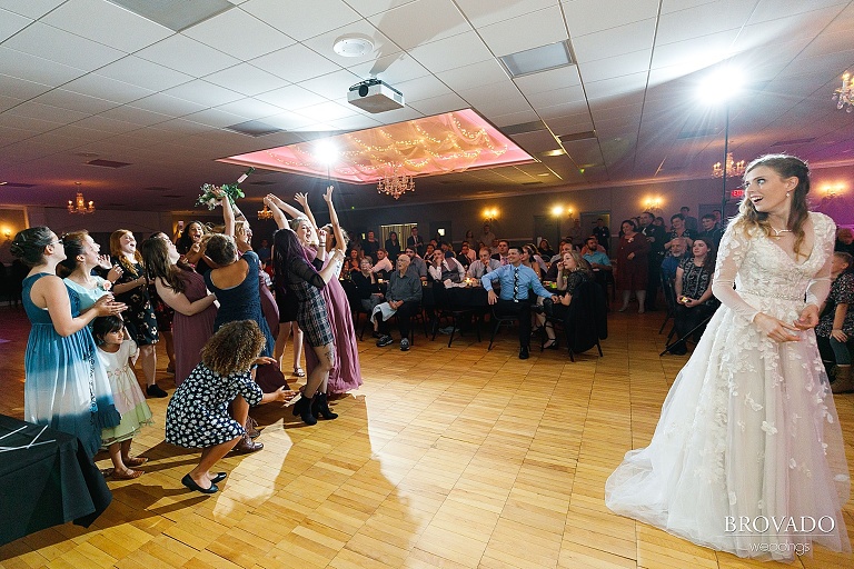 Bride watching her bouquet toss