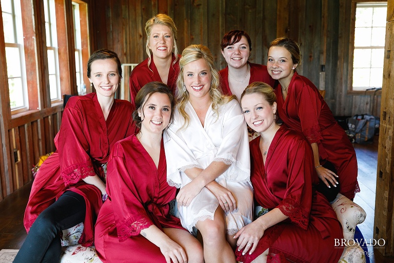 Bride and bridesmaids posing in red and white silk robes