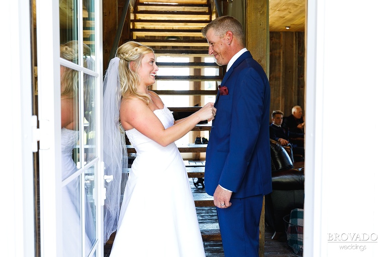 Bride fixing her father's suit coat