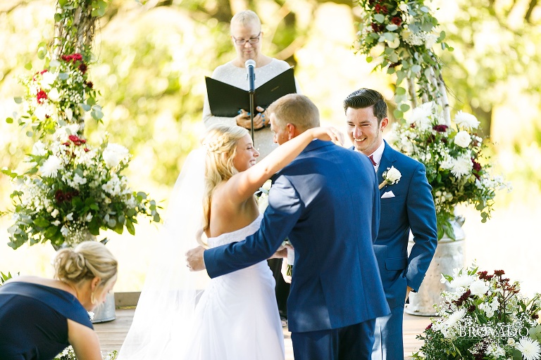 Bride hugging her father at altar