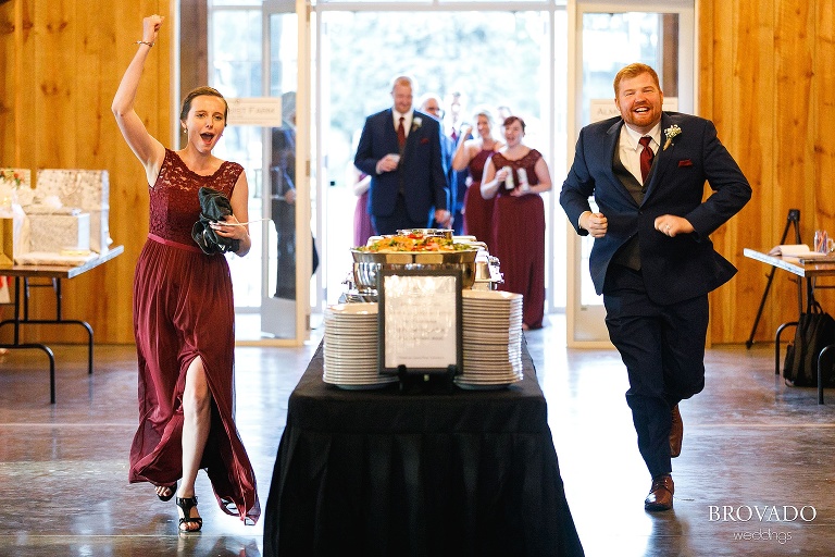 Wedding party running into reception during grand entrance