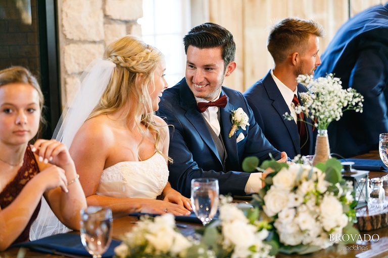 Bride smiling at groom during wedding reception