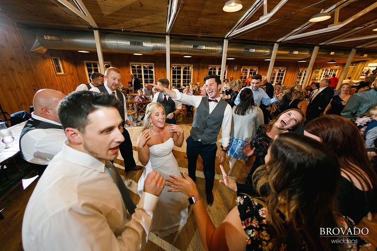 Bride and groom dancing with their friends