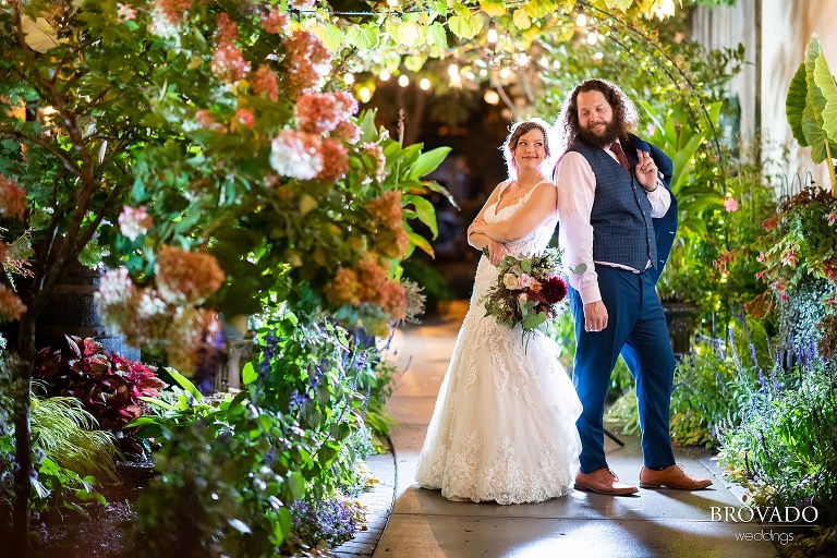 Bethany and Andy posing back to back at night at Kellerman's event center