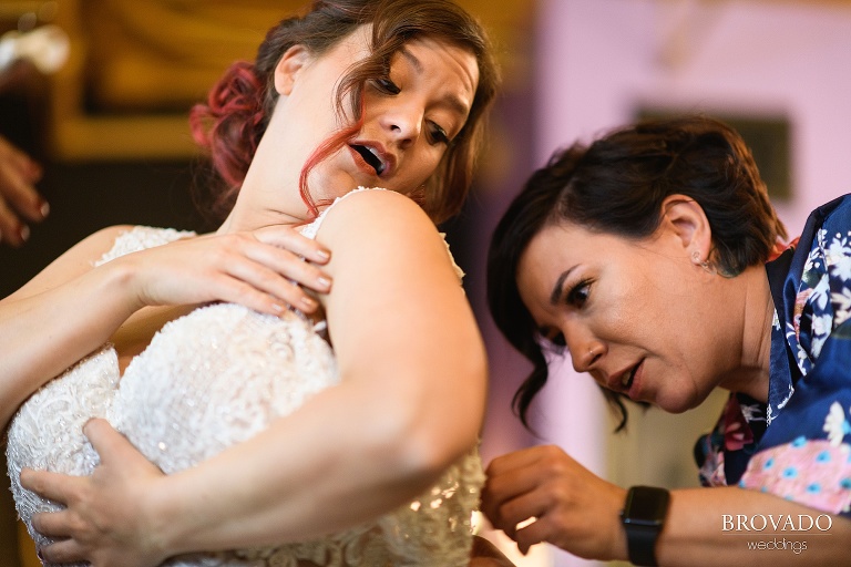 Bethany's maid of honor putting on her dress