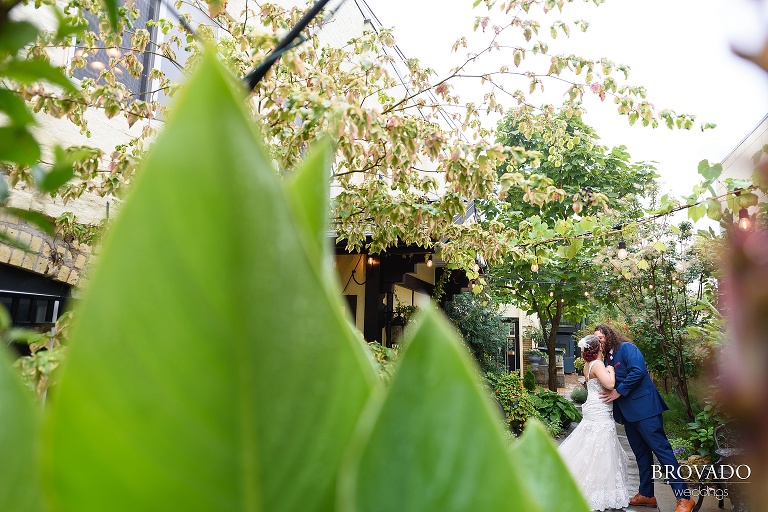 Wide angle of groom and bride kissing at kellerman's event center