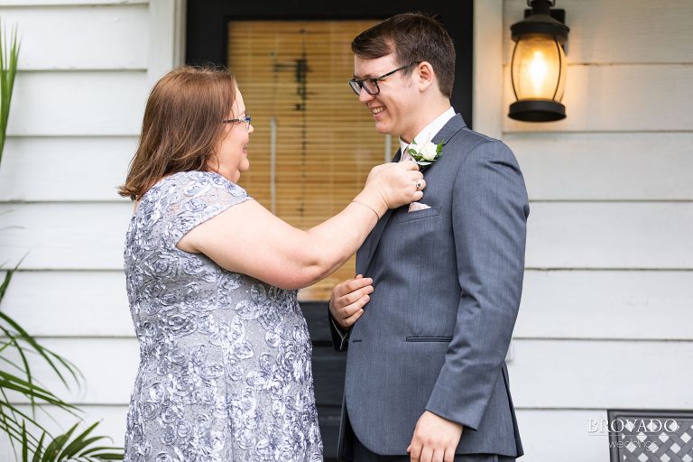 Daniel's mother adjusting his boutonniere 