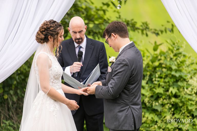 Daniel putting the ring on Heather's hand