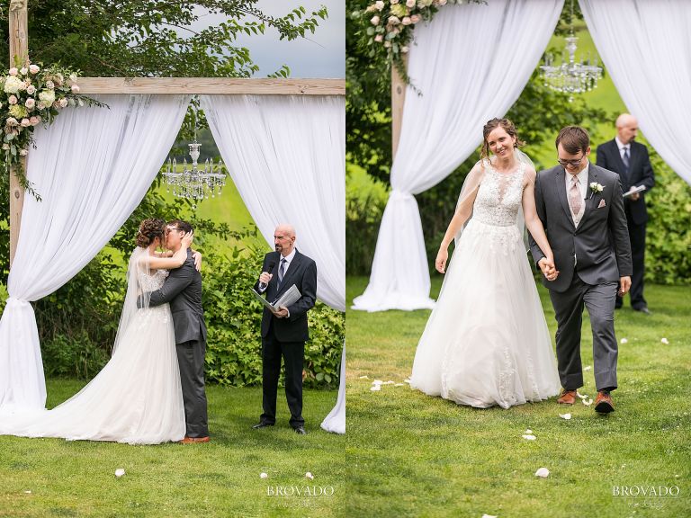 Heather and Daniel kissing and walking back down the aisle