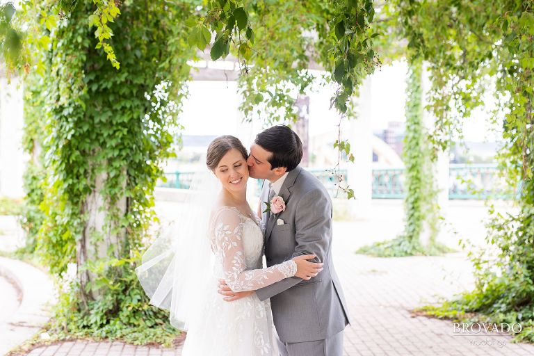 Groom kissing bride on the cheek