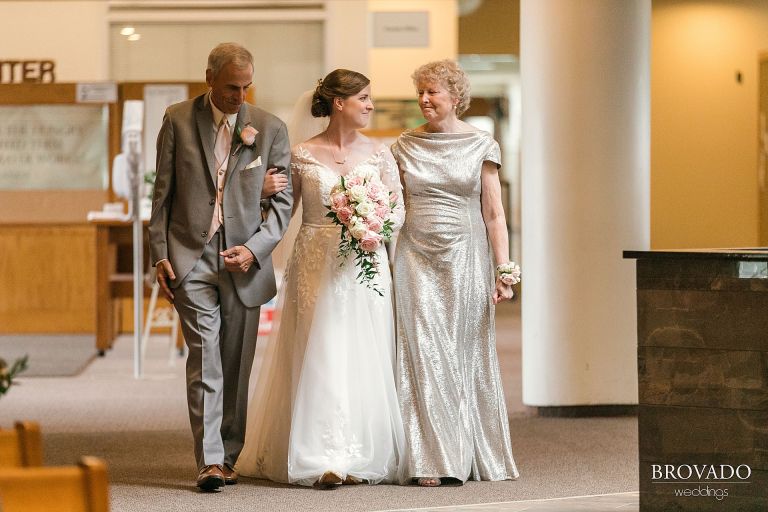 Bride walking down the aisle with her parents