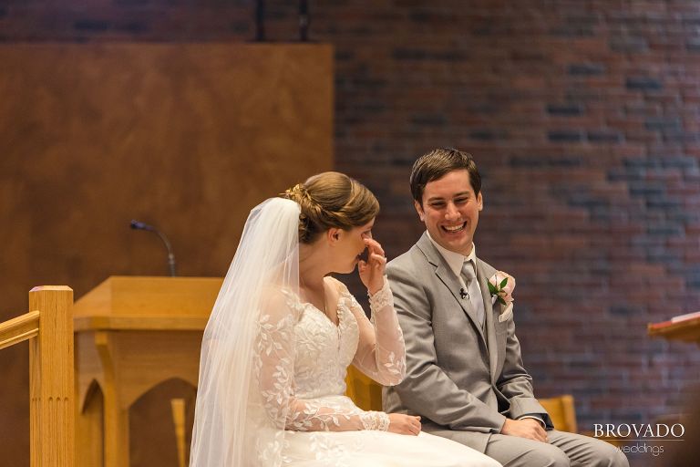 Bride crying of laughter during wedding ceremony