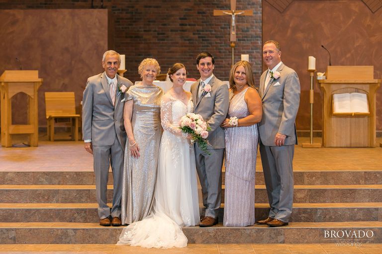 Bride and groom posing with their parents