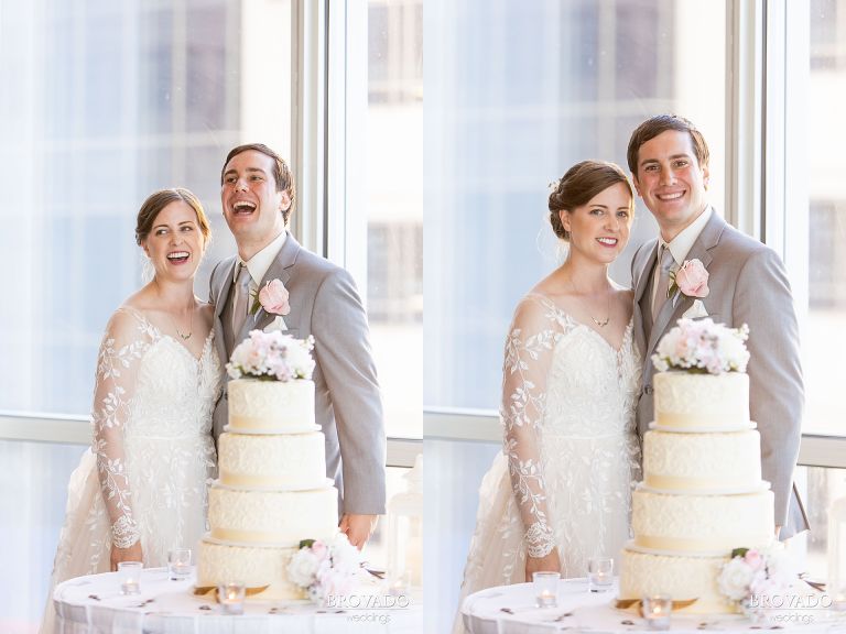 Bride and groom posing by wedding cake