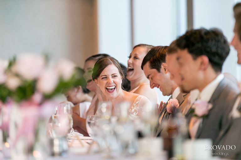 Bride laughing at wedding speech
