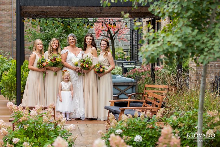 Bride posing with bridesmaids and flower girl