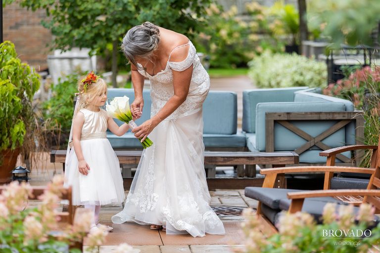 Michelle letting the flower girl smell her flowers