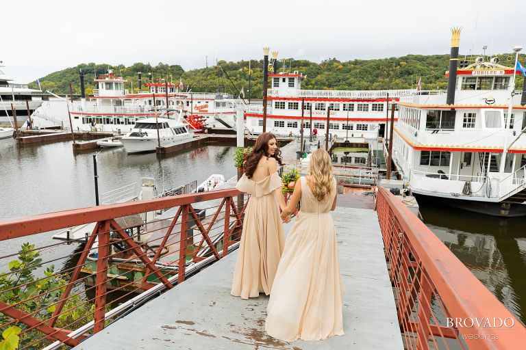 Bridesmaids walking to riverboat 