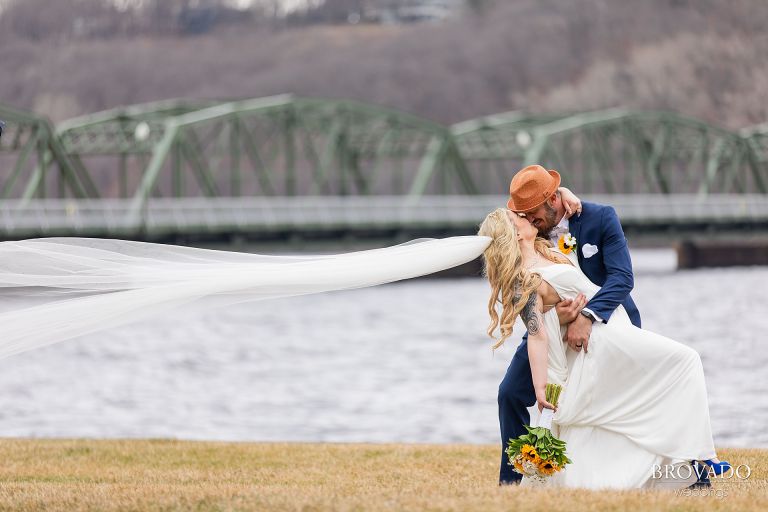 Bride and groom kissing on Stillwater river