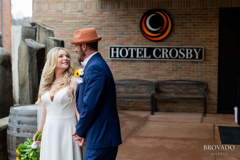 Bride and groom in front of hotel crosby