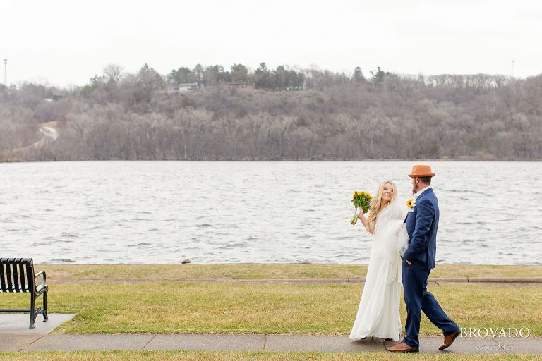 Riverside walk in wedding gown and suit