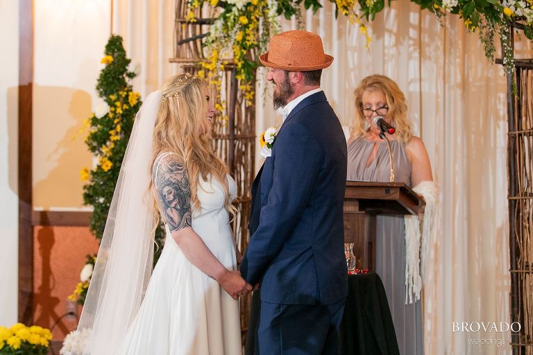 Bride and groom smiling at altar