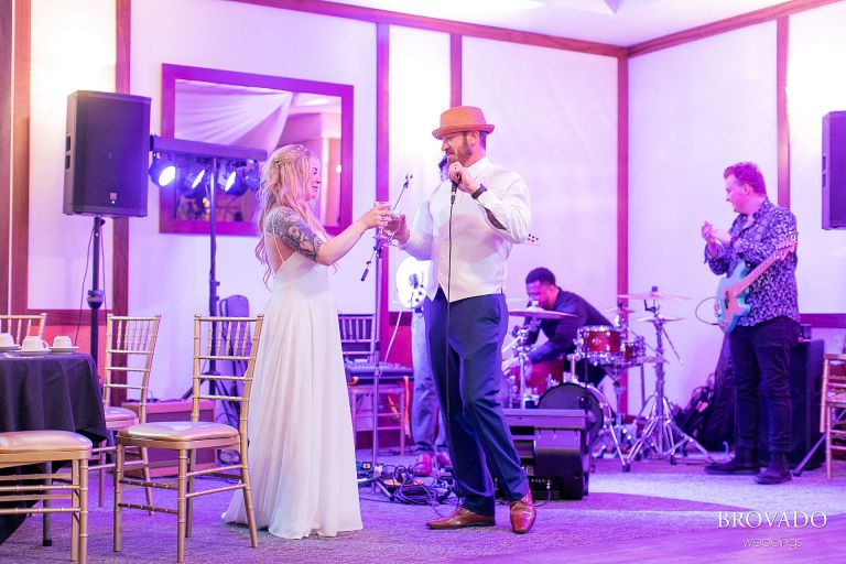 Bride and groom toasting their drinks