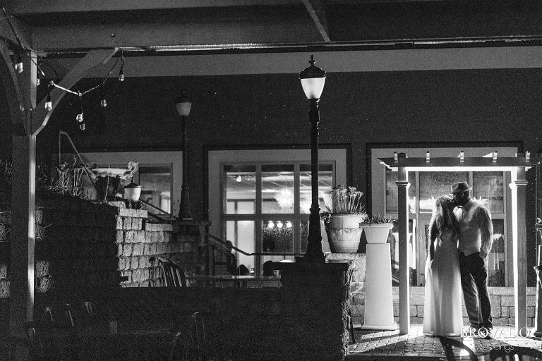 Bride and groom outdoors and backlit in black and white